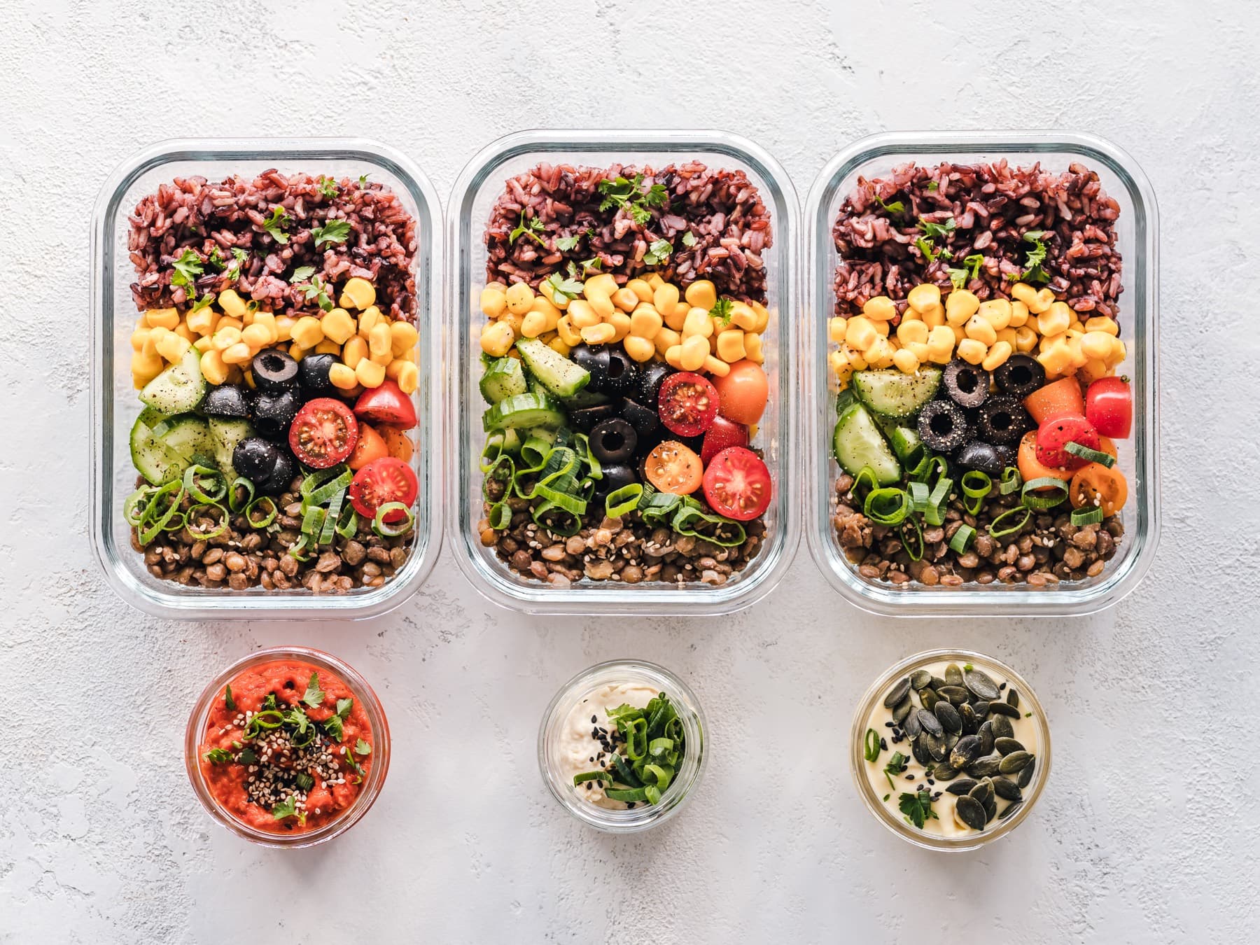 Glass meal prep containers on a neutral tabletop